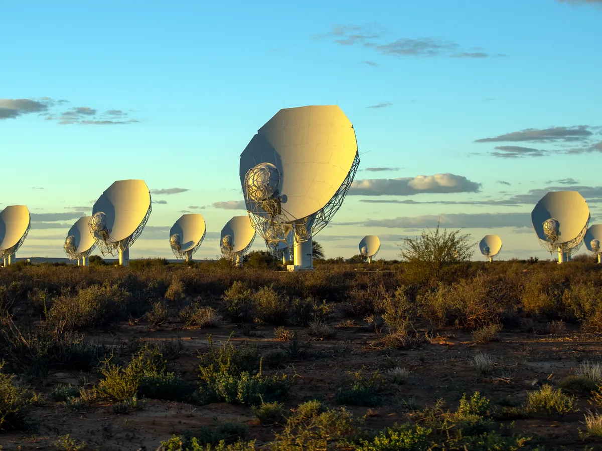 Parabolic dishes of the MeerKAT radio telescope on a plain in South Africa.